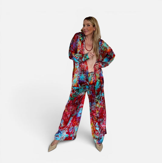 Woman wearing a colorful tie-dye outfit on a white background