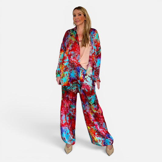 Woman wearing a colorful tie-dye outfit on a white background