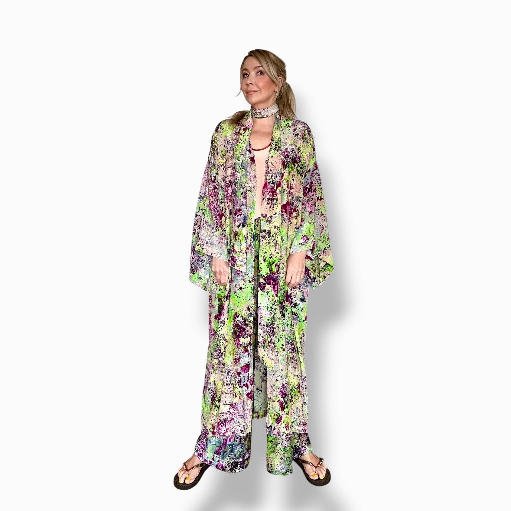 Woman wearing a floral kimono-style outfit on a white background