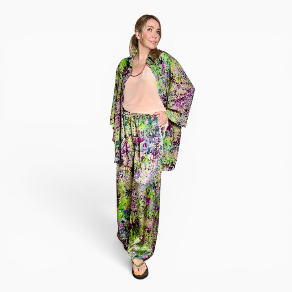 Woman wearing a colorful floral outfit on a white background