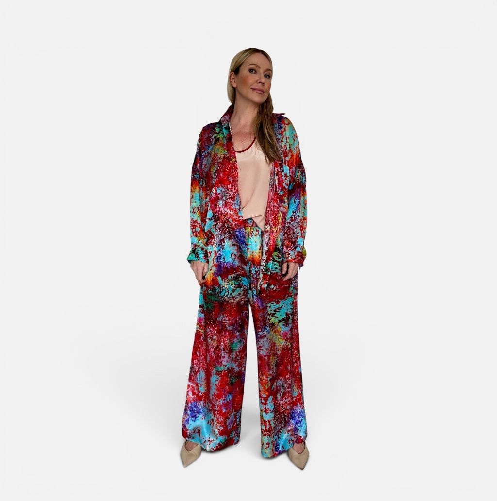 Woman wearing a colorful silk suit on a white background