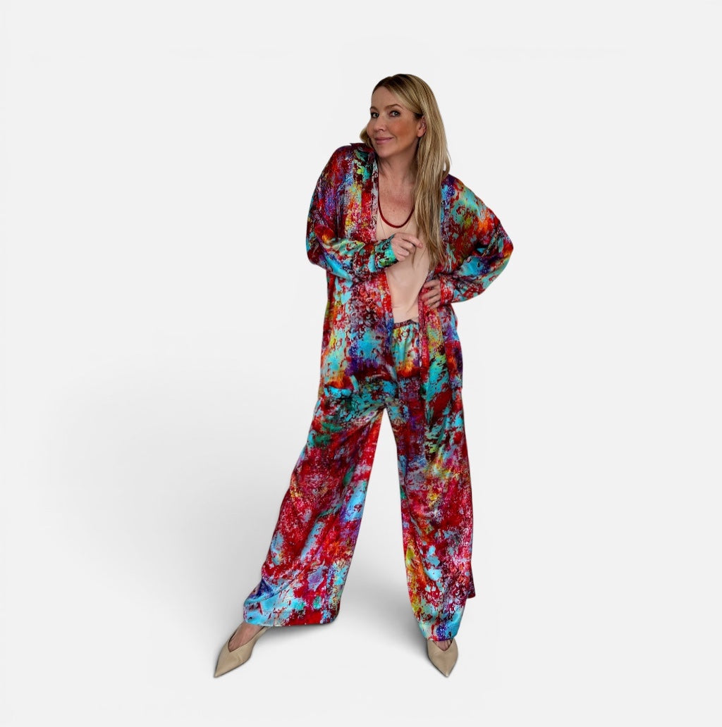 Woman wearing a colorful tie-dye outfit on a white background
