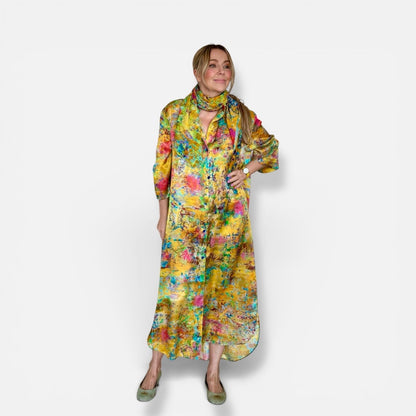 Woman wearing yellow silk kimono shirt with floral print and matching scarf on a white background