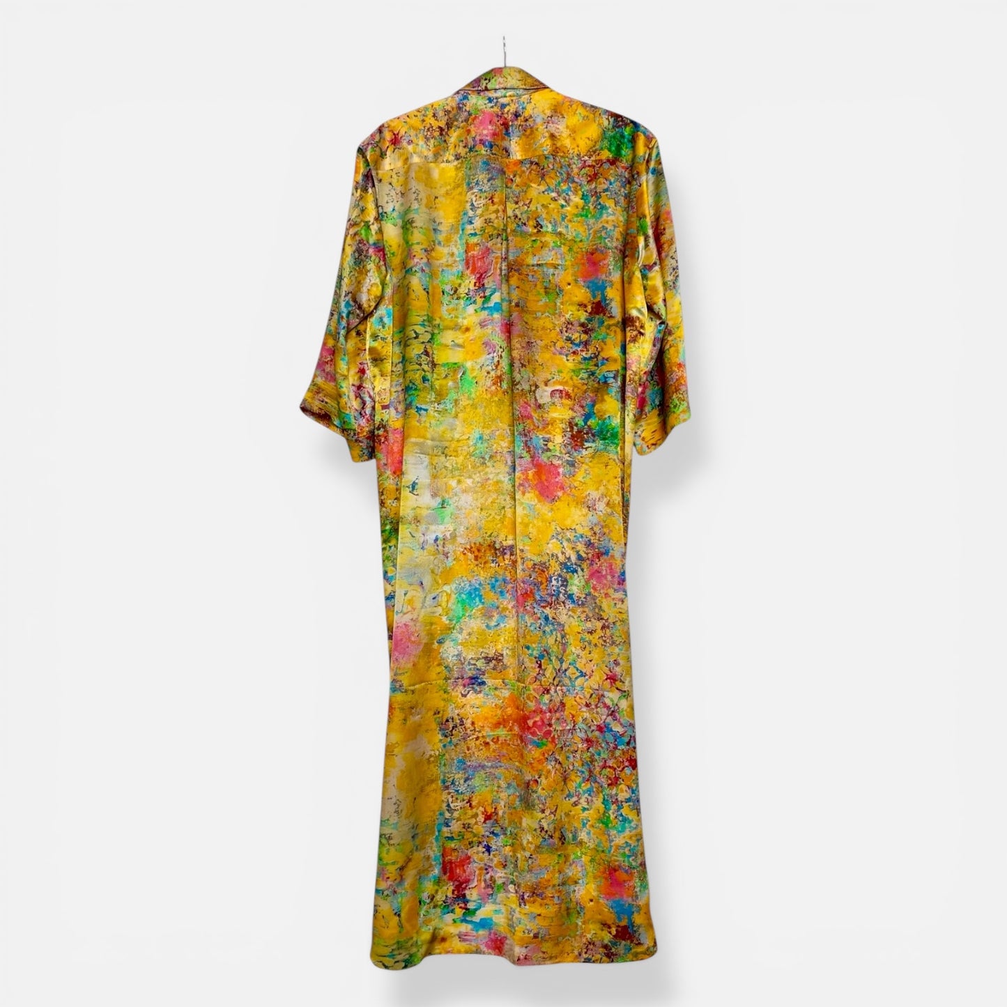 Yellow silk  abstract patterned dress on a white background

