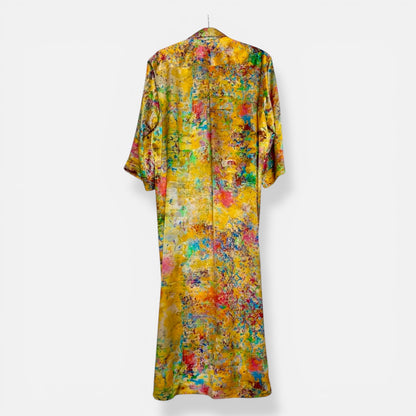 Yellow silk  abstract patterned dress on a white background

