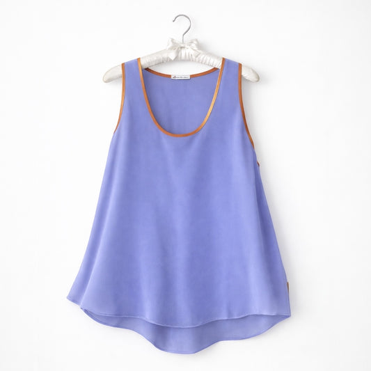 Lilac tank top with brown trim on a white hanger against a white background