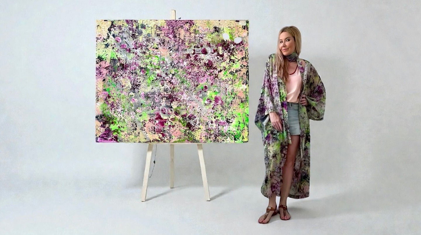 Natalia Brooks wearing a silk kimono created from her original abstract painting Lilac Dreamscape.