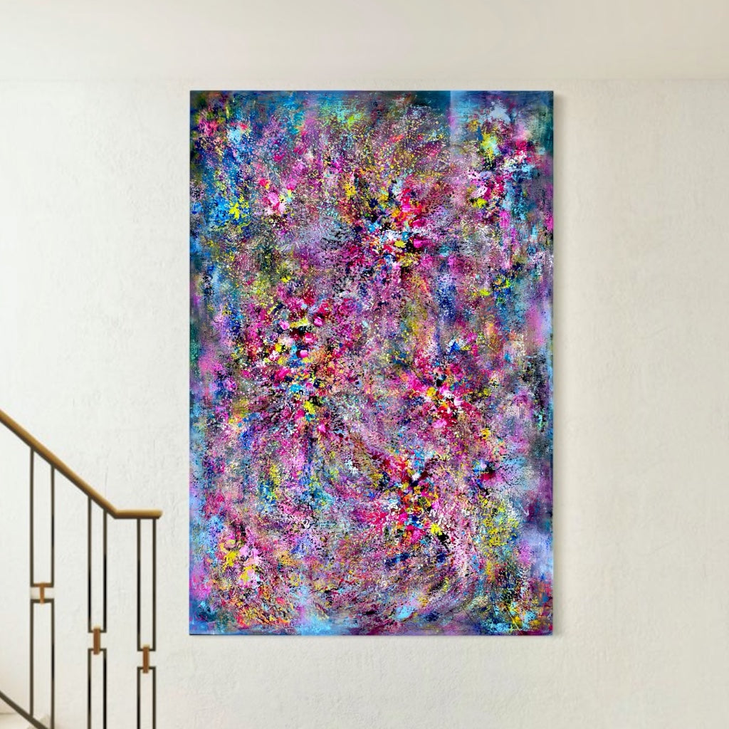 Constellation Chandelier, a large vertical abstract painting in vibrant pink, blue, turquoise, purple and yellow, displayed on a white wall beside a staircase.
