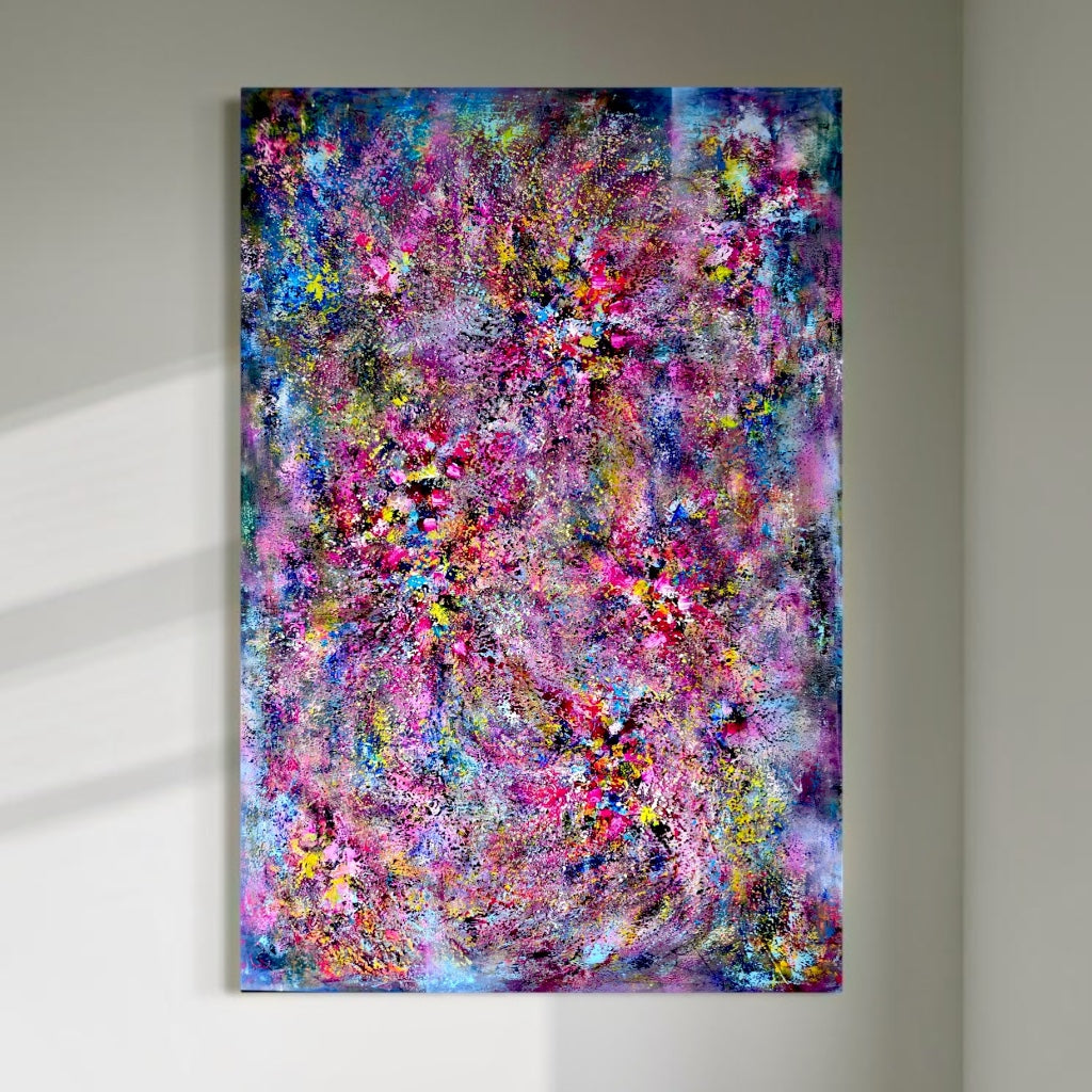 A large vertical abstract painting displayed on a light wall, filled with layered pink, blue, purple, yellow and turquoise textures resembling a sparkling chandelier.