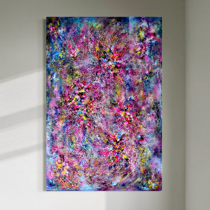 A large vertical abstract painting displayed on a light wall, filled with layered pink, blue, purple, yellow and turquoise textures resembling a sparkling chandelier.