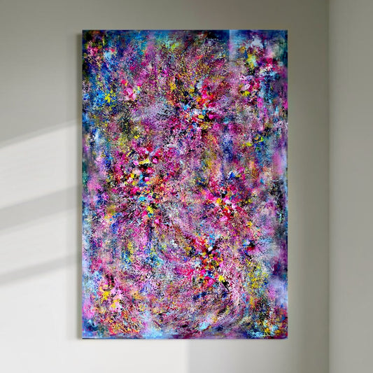 A large vertical abstract painting displayed on a light wall, filled with layered pink, blue, purple, yellow and turquoise textures resembling a sparkling chandelier.
