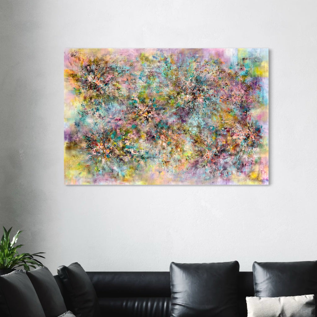 Abstract multicolored painting on a wall above a black leather sofa.