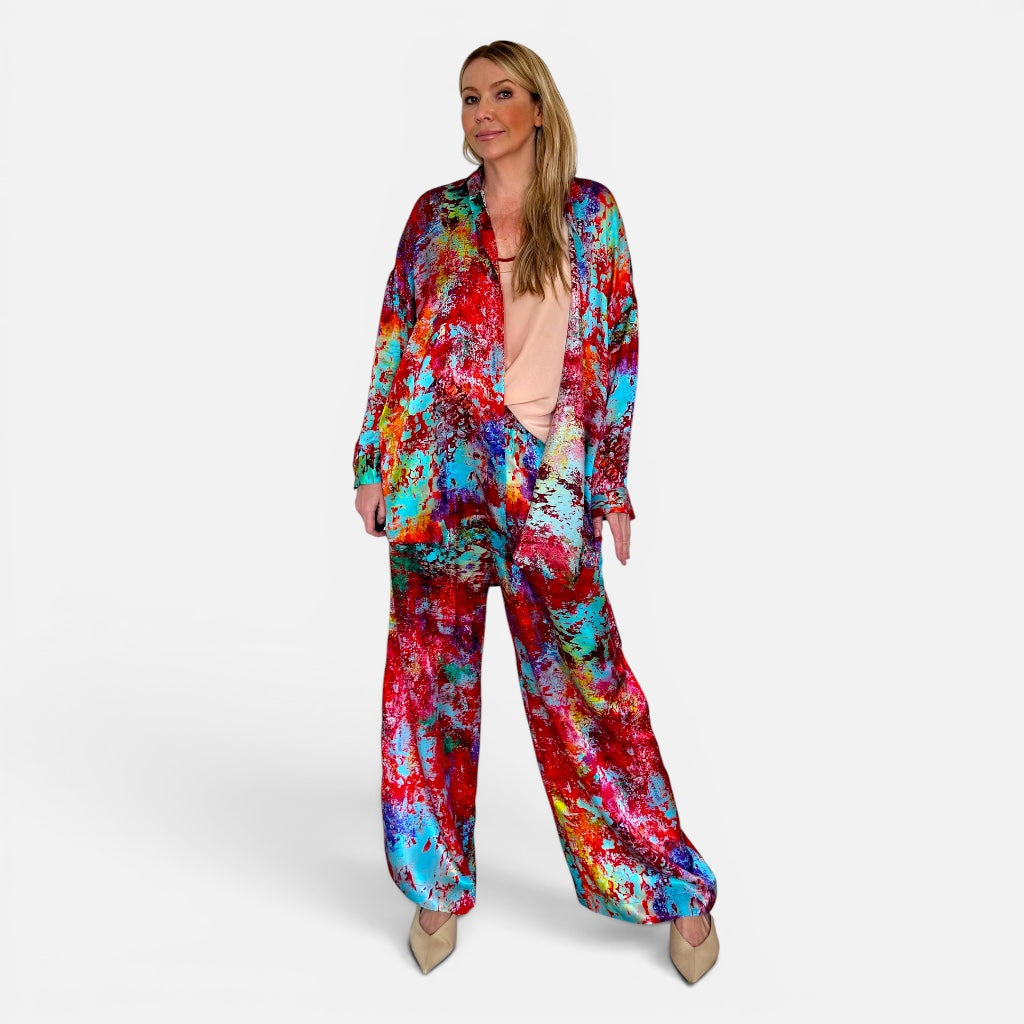 Woman wearing a colorful tie-dye outfit on a white background