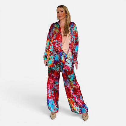 Woman wearing a colorful tie-dye outfit on a white background