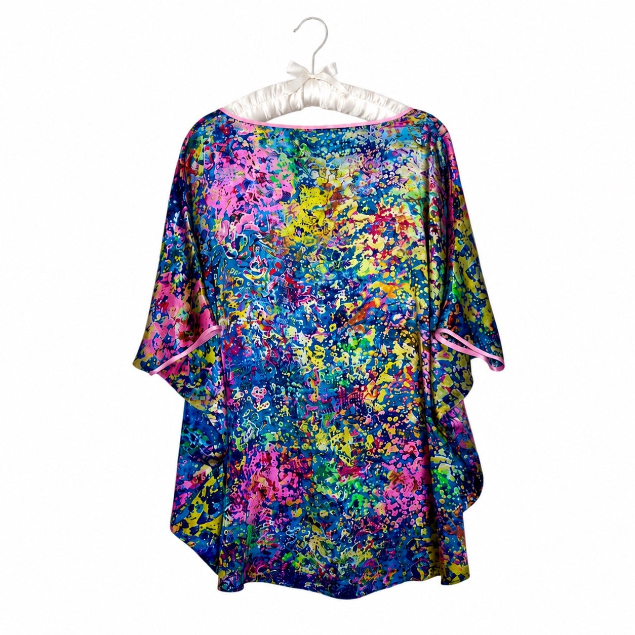 Colorful floral dress on a white hanger against a white background