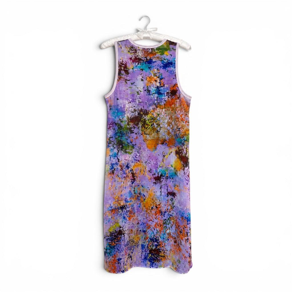 A sleeveless A-line dress with an abstract multicolor paint-splatter pattern on a purple and blue base, hanging on a white plastic hanger against a white background.