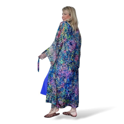 Woman wearing a colorful floral dress on a white background