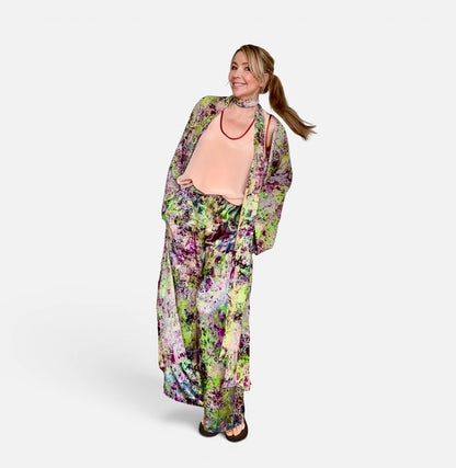 Woman wearing a floral dress and cardigan on a white background