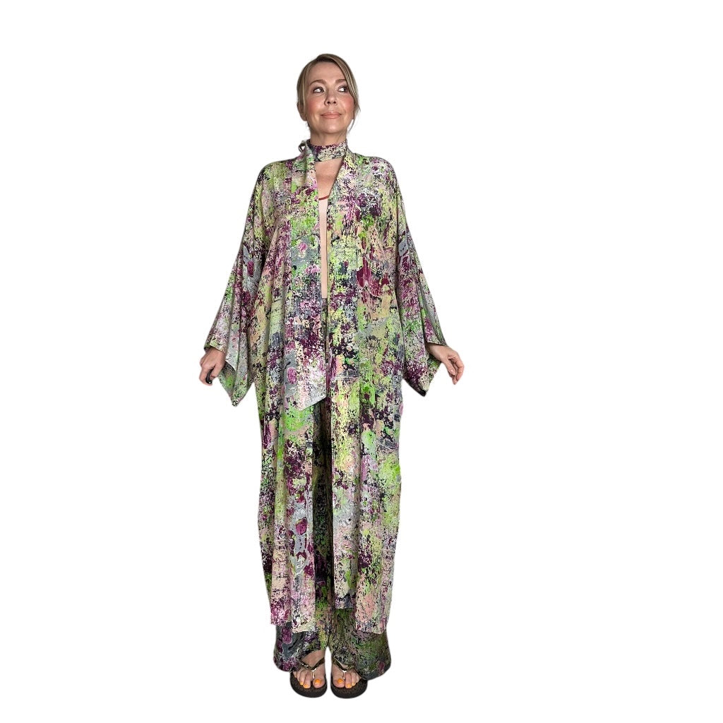Woman wearing a floral kimono-style dress on a white background