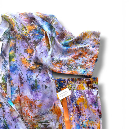 Close-up detail of a silk kimono and matching trousers, showcasing fine tailoring on a white background.