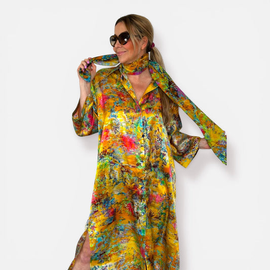 Woman wearing yellow silk kimono shirt with floral print and matching scarf on a white background