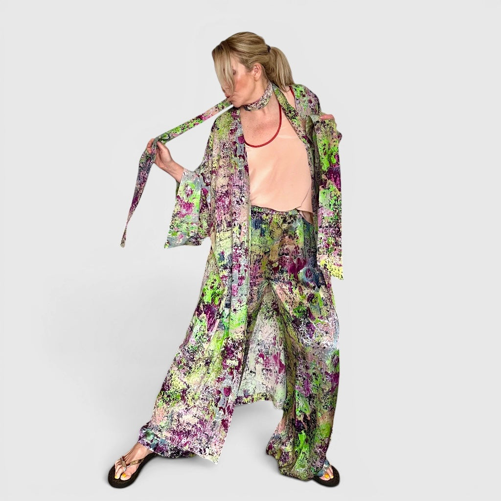 Woman wearing a colorful floral outfit on a white background