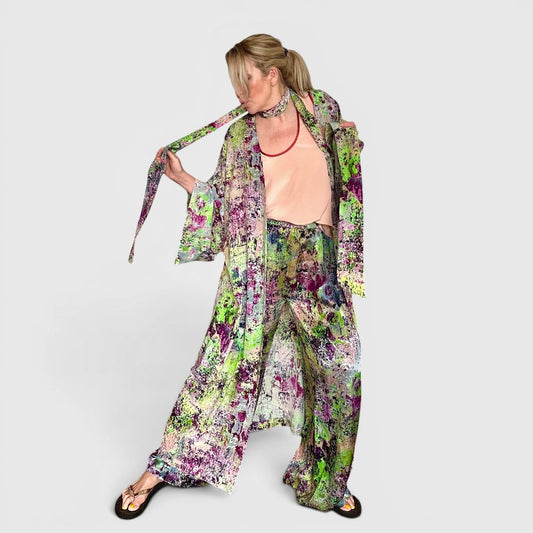 Woman wearing a colorful floral outfit on a white background
