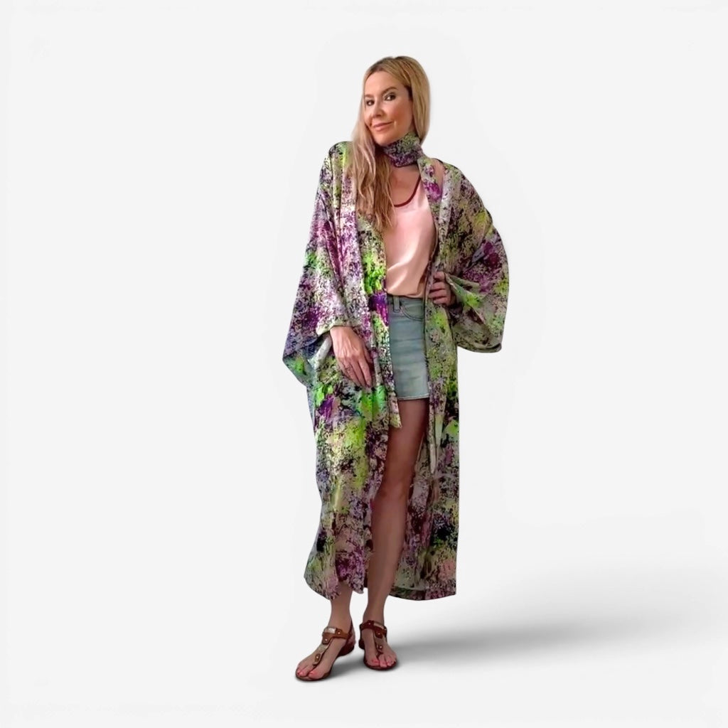 Woman wearing a floral kimono-style garment on a white background
