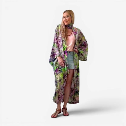 Woman wearing a floral kimono-style garment on a white background