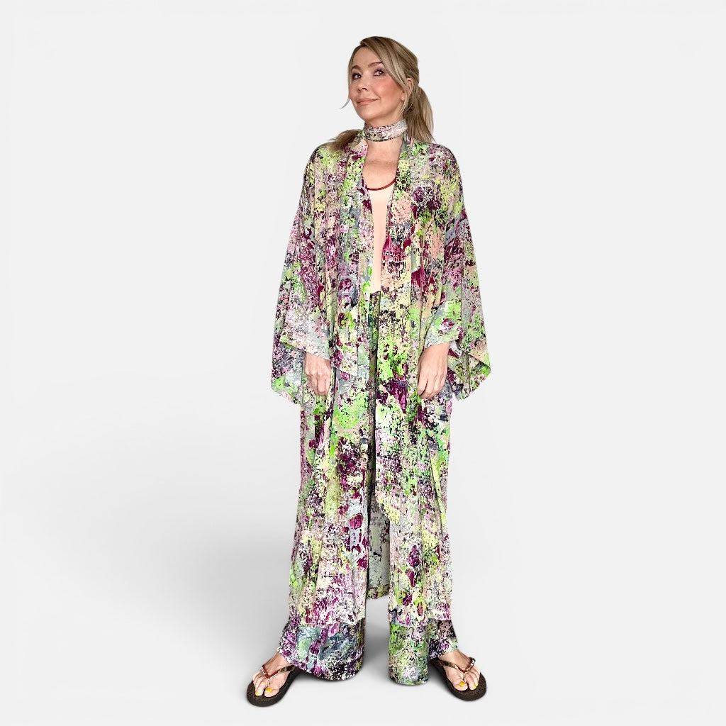 Woman wearing a floral kimono-style outfit on a white background
