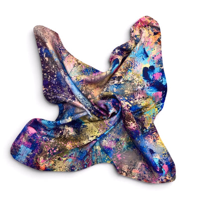A lightweight silk scarf with a vibrant, multicolored abstract paint-splatter pattern, shown draped on a clean white background.