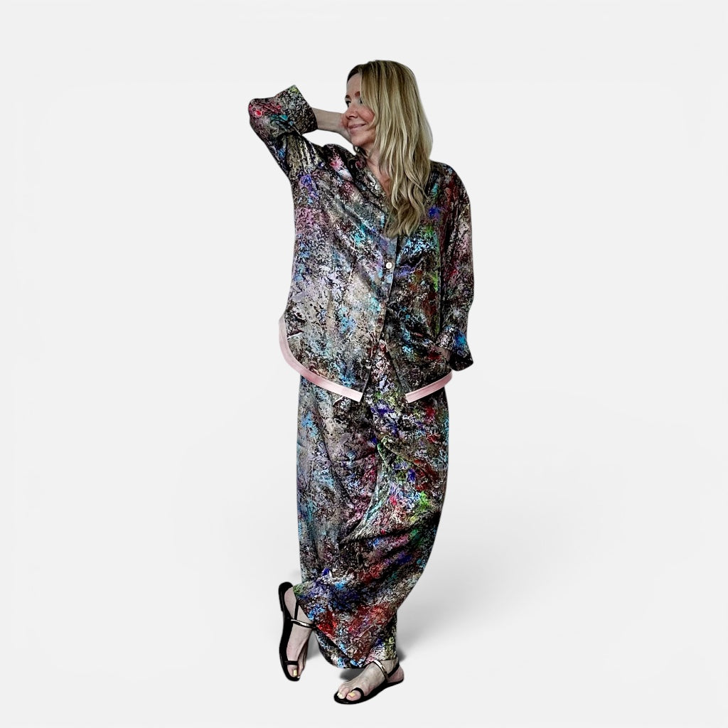 Woman wearing a colorful patterned outfit on a white background