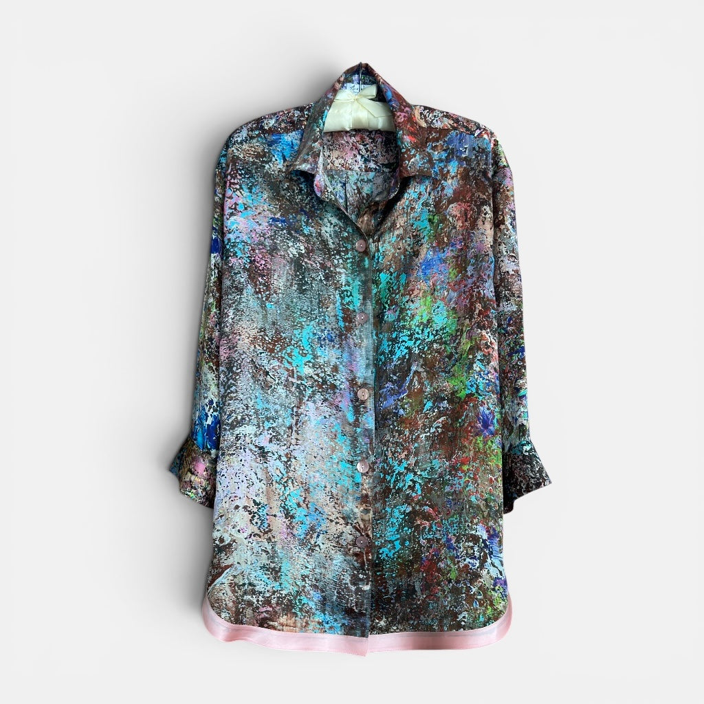 Colorful patterned shirt on hanger on a white background
