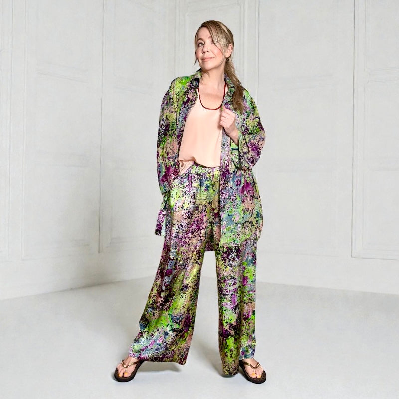 Person wearing a colorful floral outfit on a white background
