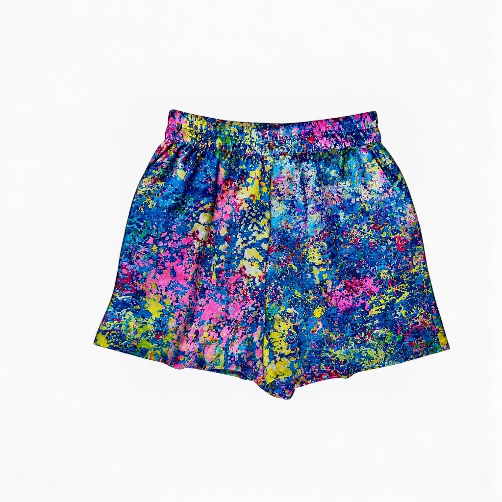 Colorful splatter-patterned shorts on a white background