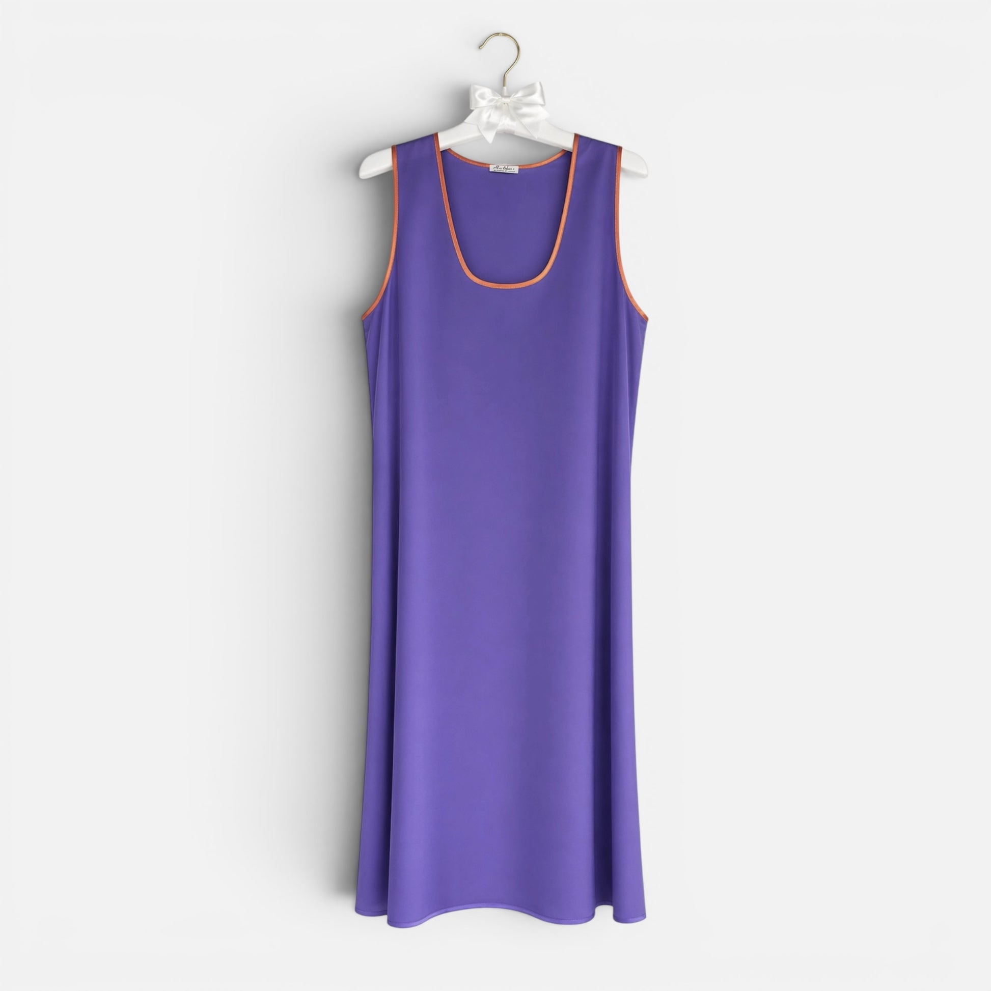 Purple sleeveless dress on a white hanger against a white background