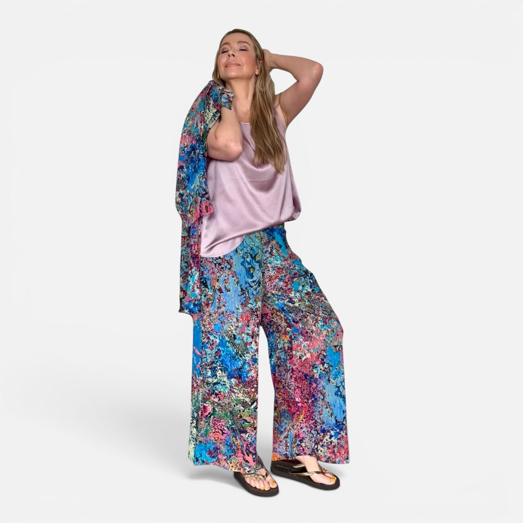 Woman wearing a colorful floral outfit on a white background