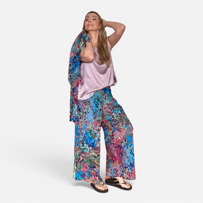 Woman wearing a colorful floral outfit on a white background