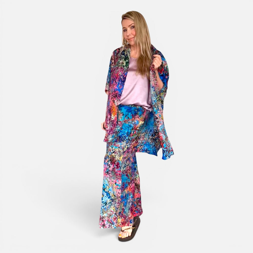 Woman wearing a colorful floral outfit on a white background