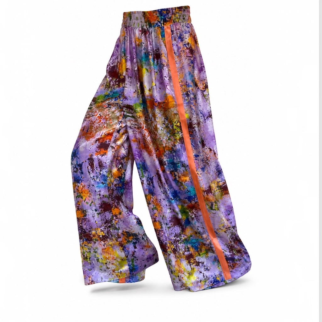 Colorful patterned pants with a prominent orange stripe on a white background